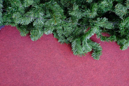 Christmas, New Year, Winter border with realistic branches of Christmas tree Xmas element for festive design isolated on red backgroundの写真素材