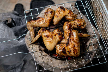 Chicken wings on barbecue grill with fire, Top view.の写真素材