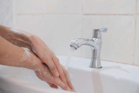 Woman washing hands, Corona virus travel prevention wash hands with soap and hot water. Hand hygiene for coronavirus outbreak. Protection by washing hands frequently conceptの写真素材