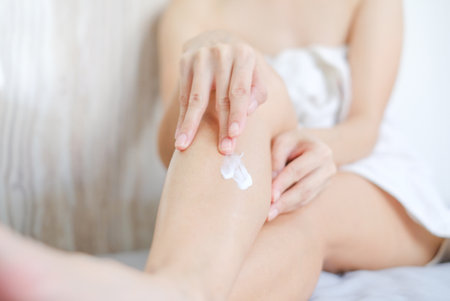 Woman applying natural cream, Woman moisturizing her leg with cosmetic cream, Spa and Manicure concept.の写真素材