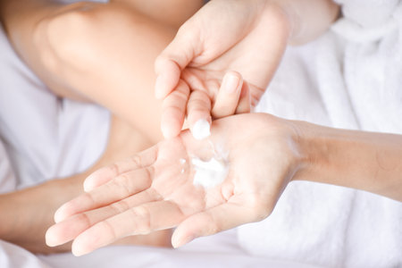 Woman applying natural cream, Woman moisturizing her hand with cosmetic cream, Spa and Manicure concept.の写真素材