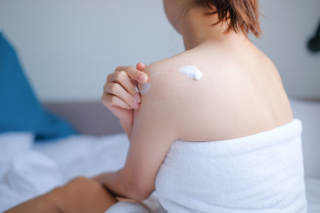 Woman applying natural cream, Woman moisturizing her back with cosmetic cream, Spa and Manicure concept.の写真素材