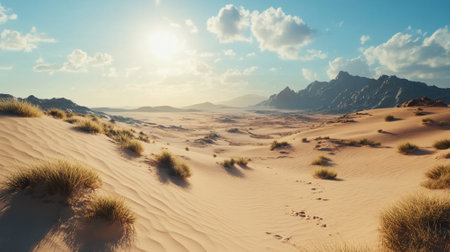 Wide-open desert landscape with soft sand dunes, a bright blue sky, and ample foreground space for adding text.の素材
