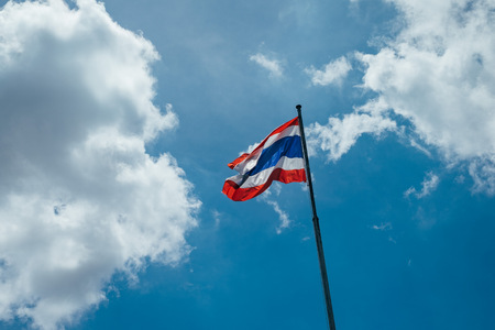 thai flag pole with blue sky and cloudの写真素材