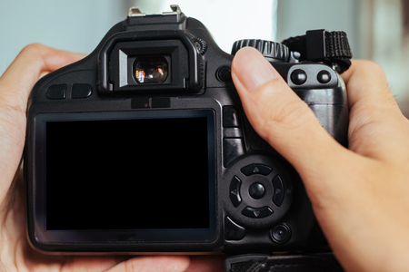 DSLR camera on human handsの写真素材
