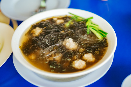 Clear soup with seaweed and minced pork.の写真素材