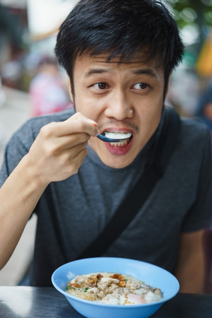 Asian man eating congree.の写真素材