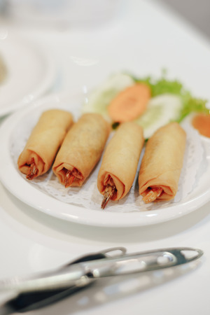 Spring Rolls with Porks and Shrimps in white dish at restuarant.の写真素材