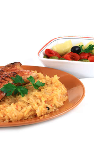 Close up of a bacon with potatoes or cabbage arranged in an orange plateの写真素材