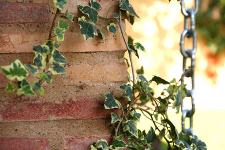 Medieval wall of a house in spain, with a chain in secondary planの写真素材