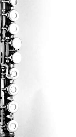 Old silver flute part on white の写真素材