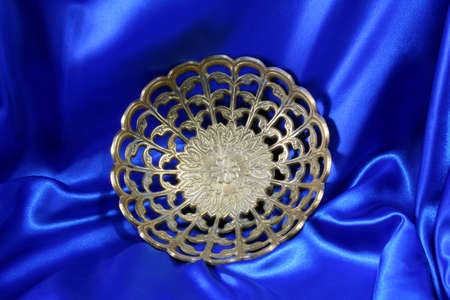old silver fruit dish, with a satin blue background