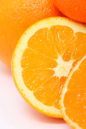 Fresh mandarin and orange close-up on a white 