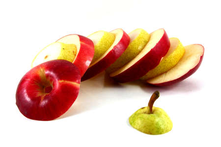 Red apple cut in sections and yellow ripe pear isolated on whiteの写真素材