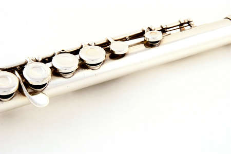 Old silver flute part on white の写真素材