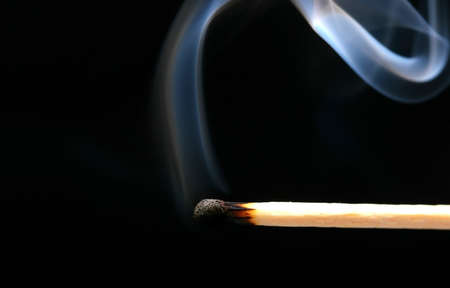 Smoking match on black as a hope conceptの写真素材