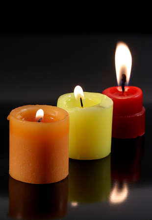 Candles on black , reflecting their lightsの写真素材