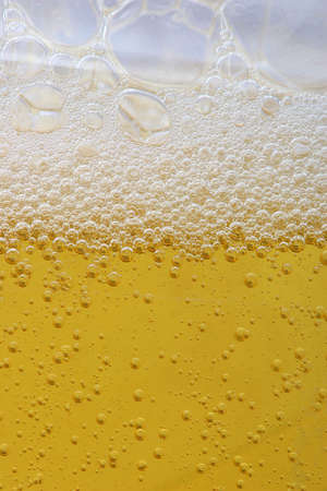 Bubbles in beer or dishes soap shampoo close-upの写真素材