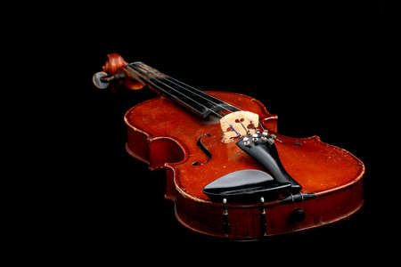 Old wooden violin entirely isolated on black