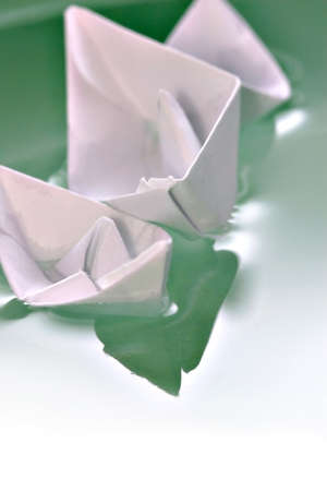 Boat made of paper floating on the waterの写真素材