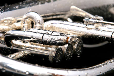 Fluegelhorn close-up on black with water drops on itの写真素材
