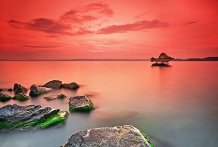 Nice sunset with rocks in the foreground の写真素材