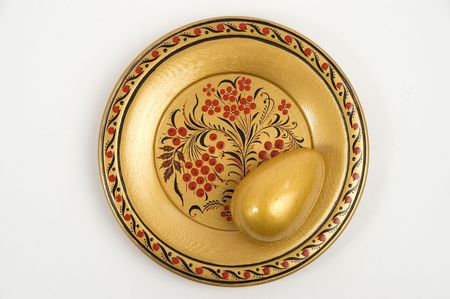 Colour wooden dish with figure and gold egg.の写真素材