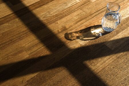 Decanter with water on a wooden floor.の写真素材