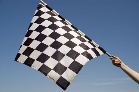 Auto racing checkered flag on a background of the  blue sky.の写真素材