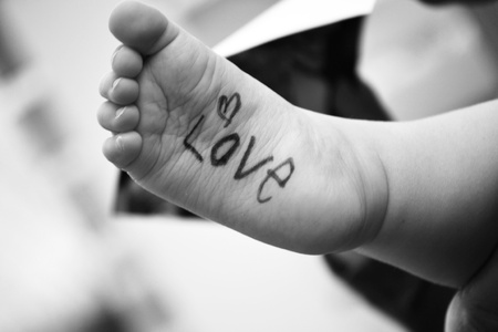 Baby s foot with word love written on it