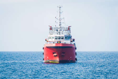supply boat in oilfield and cargo take on front