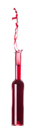 Red wine pouring from bottle - inverted  white backgroundの写真素材