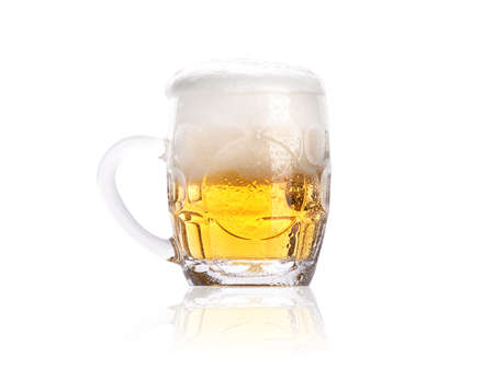 Frosty small mug of light beer with foam isolated on a white backgroundの写真素材
