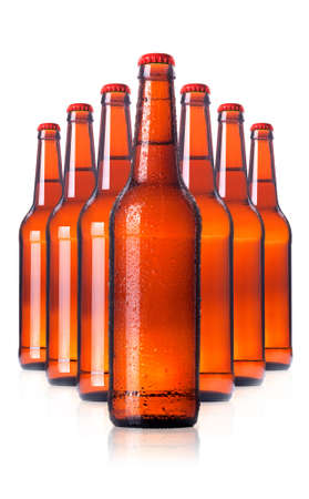 row of beer Bottles with drops isolated on white background.