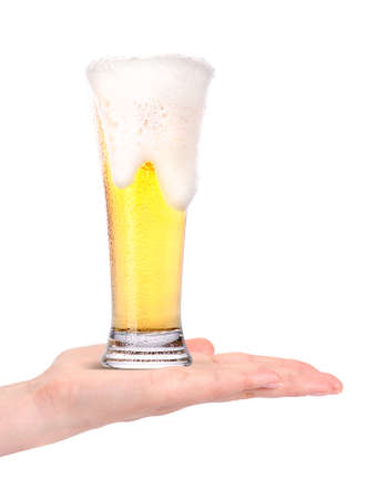 hand offering glass of beer  in ice isolated on a white background making toastの写真素材