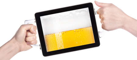 hands holding Touch screen tablet computer with beers making toastの写真素材