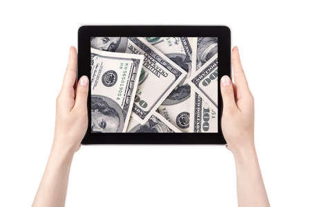 lot of cash on a Tablet pc screen with woman hands isolated on a white backgroundの写真素材