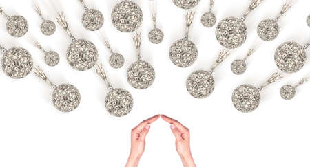 Financial crisis - an old bombs made of money and hands showing home signの写真素材