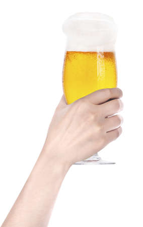 Frosty glass of beer with hand making toastの写真素材