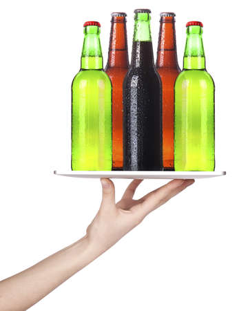 Waitresses hand holding a silver serving tray with beer  isolatedの写真素材