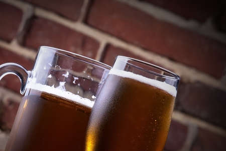background with Glass of light beer on a dark pubの写真素材