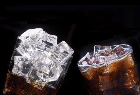set of Fresh cola drink  with ice and splash on a black background