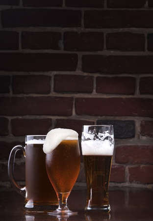 background with Glass of light beer on a dark pubの写真素材
