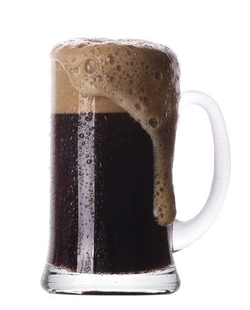 Frosty glass of dark beer isolated on a white background