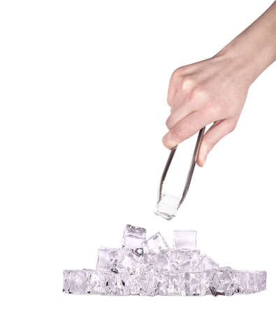 Ice cubes isolated on a white background with hand and tongsの写真素材