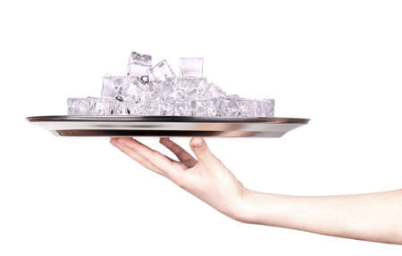 silver tray full of ice with hand isolatedの写真素材