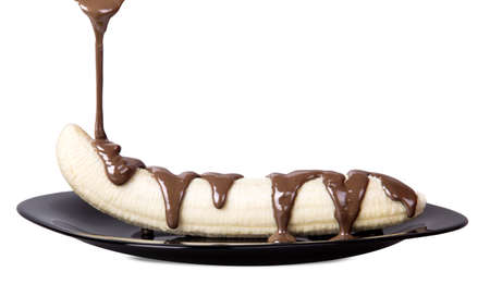banana with chocolate isolated on a whiteの写真素材