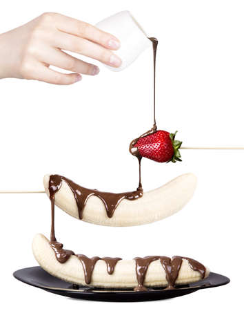 temptation concept - strawberries and banana with chocolate isolated on a white backgroundの写真素材