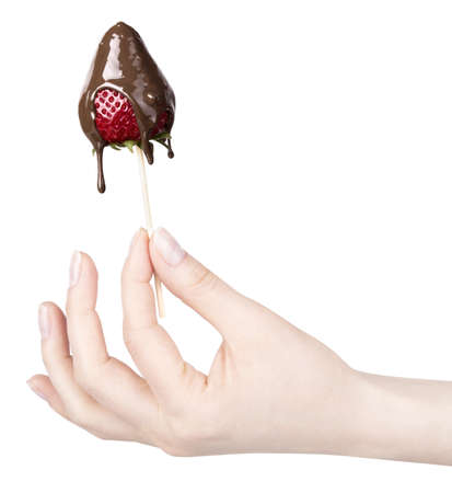 strawberries and chocolate with hand on a white backgroundの写真素材