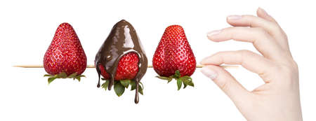 strawberries and chocolate with hand on a white backgroundの写真素材